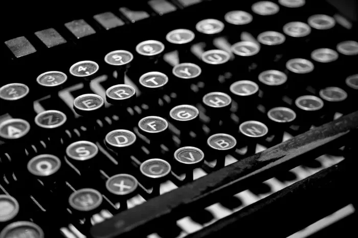 A black and white key board of a vintage typewriter.